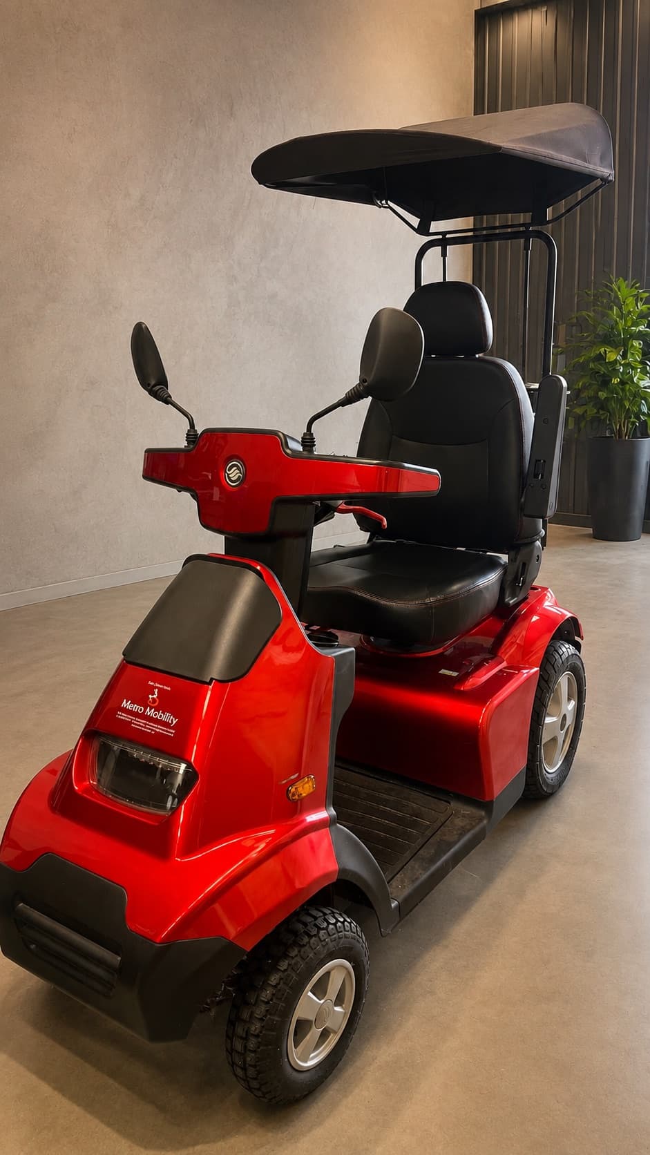 Red four-wheel mobility scooter with a canopy at Battery Factory Direct in Maddington